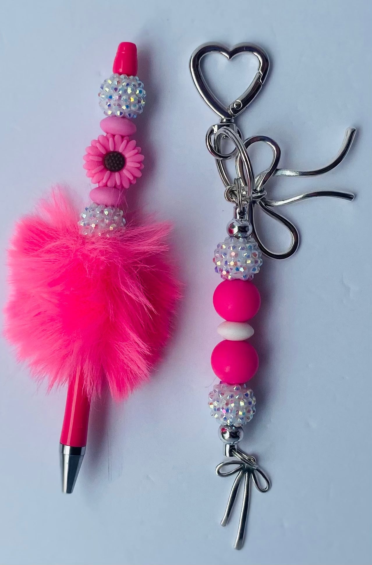 Pink fluffy keychain and beaded bag charm with heart-shaped clip and ink pen set
