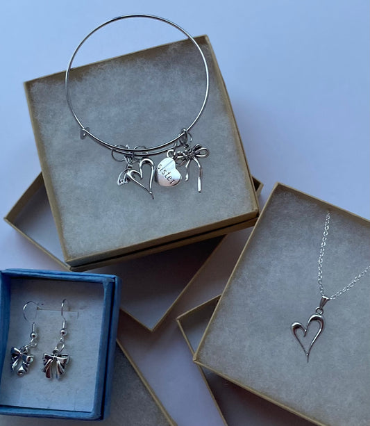 Sister gifts set with heart pendant necklace, bow earrings, and charm bangle bracelet.