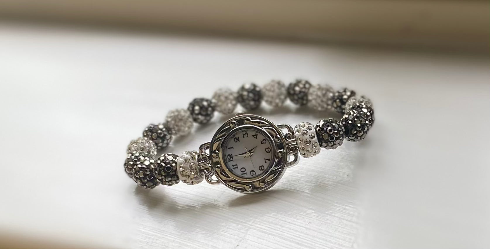 Shiny analog watch with shamballa bead bracelet set.